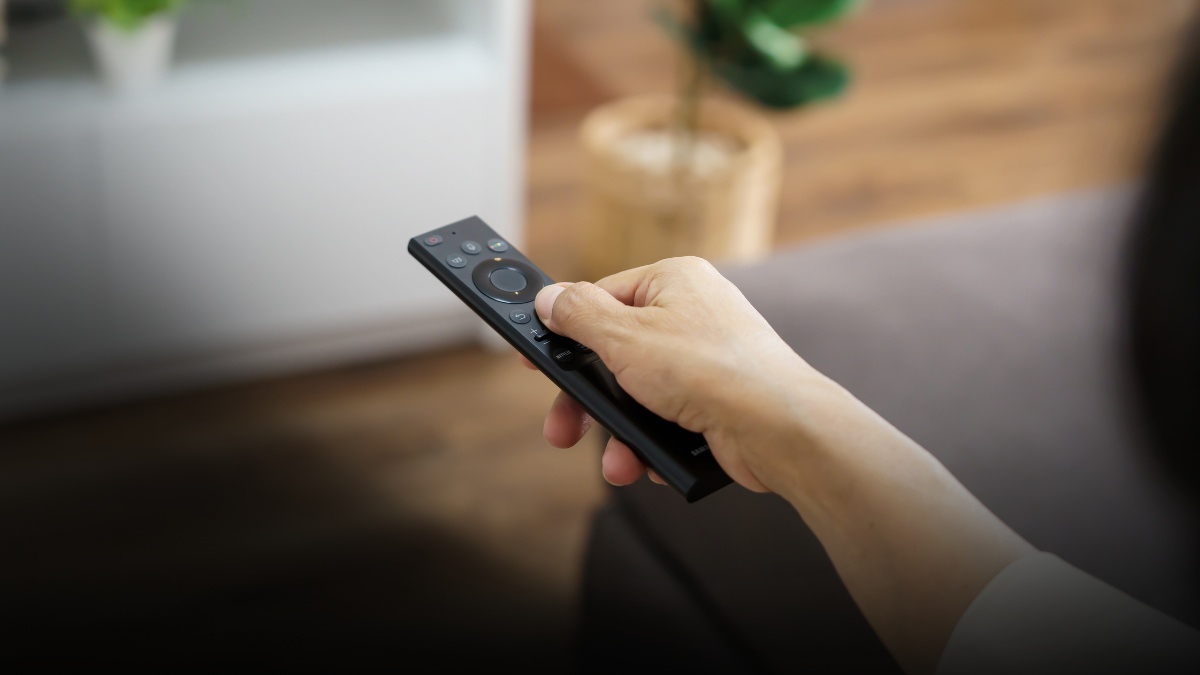 Salon moderne avec grand téléviseur 4K, barre de son et lumière naturelle